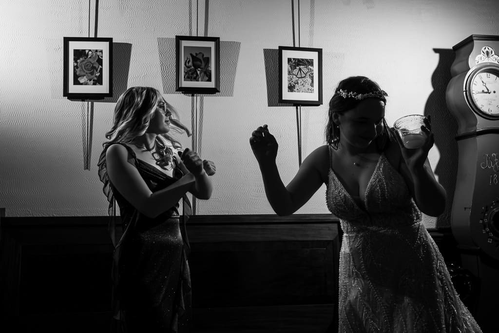 Bride and a woman dancing during a French inspired wedding near Kansas City. Wyethtootle Mansion in Saint Joseph.