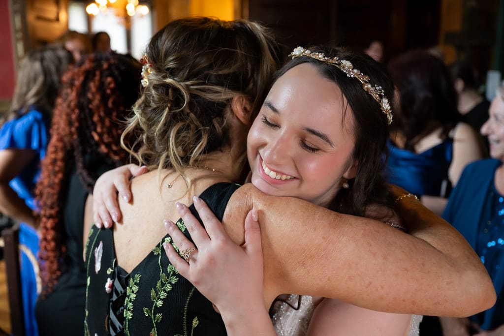 Bride hugging her mother after the ceremony at her French-inspired wedding at Wyeth-Tootle Mansion in St. Joseph, Missouri
