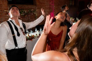 Groom and guests wildly dancing during a multicultural wedding at Union Kansas City