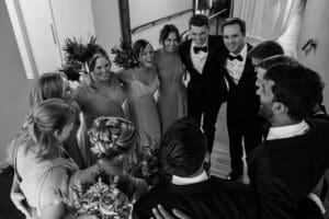 Wedding party celebrating the couple in a circle just after the ceremony