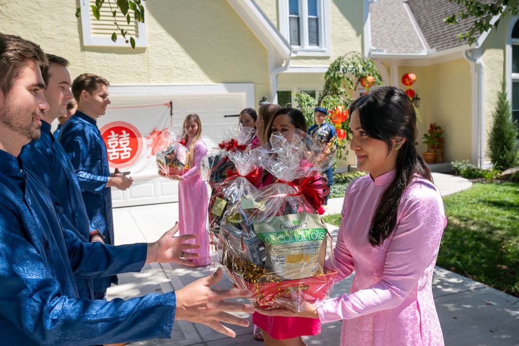 Bridesmaid receiving gifts during Vietnamese tea ceremony