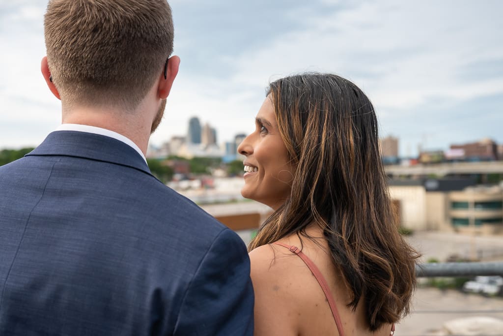 Wedding guests looking out at the Kansas City skyline view from the terrace at Boulevard Brewing Company