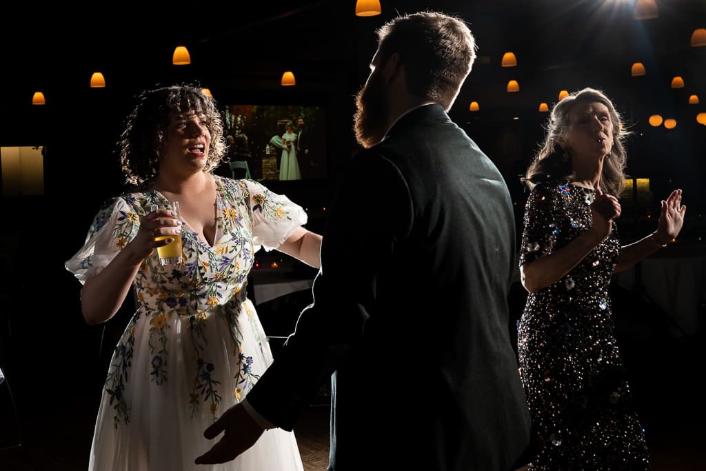 Bride holding a glass of beer while dancing with the groom at a Boulevard Brewing Company wedding
