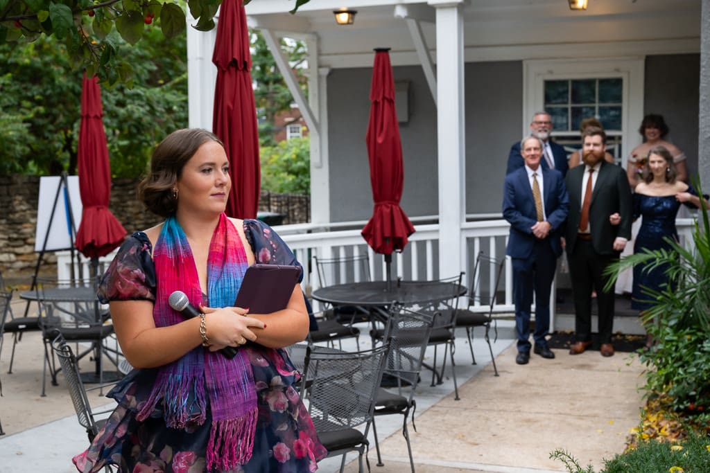 Officiant opening the wedding ceremony on the patio as the groom and his parents wait, Southmoreland on the Plaza Kansas City