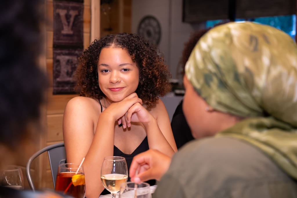Young guest smiling at the reception table during a lesbian wedding near Kansas City