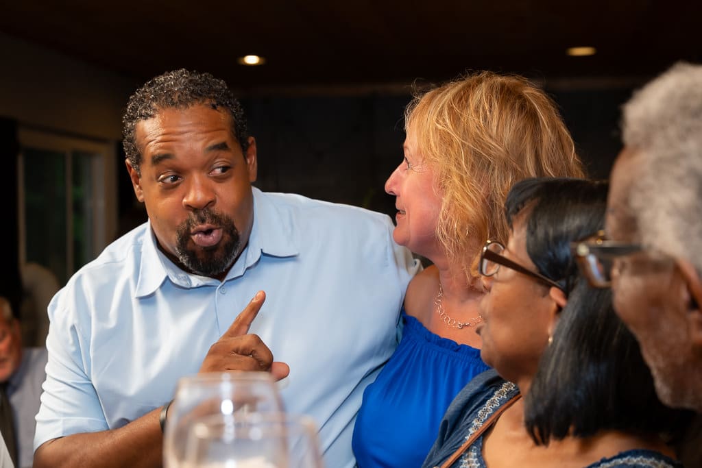 Guest telling a lively story to friends at the wedding reception