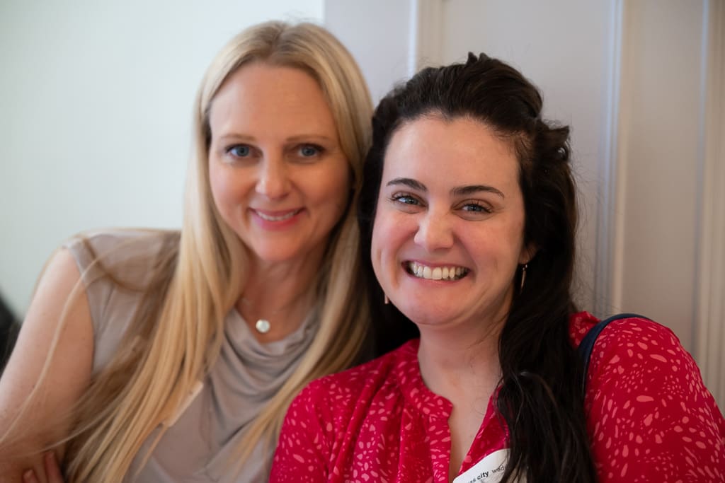 Two wedding vendors smiling cheek to cheek at a networking event at Melrose Abbey
