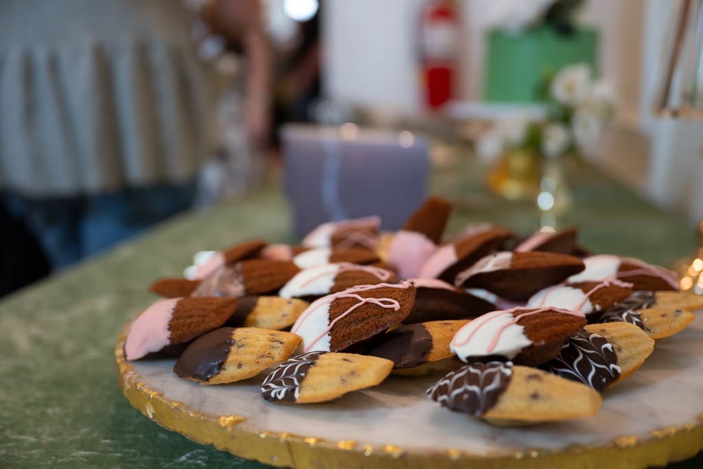 Chocolate dipped madeleines on a marble tray at a wedding vendor networking event at Melrose Abbey