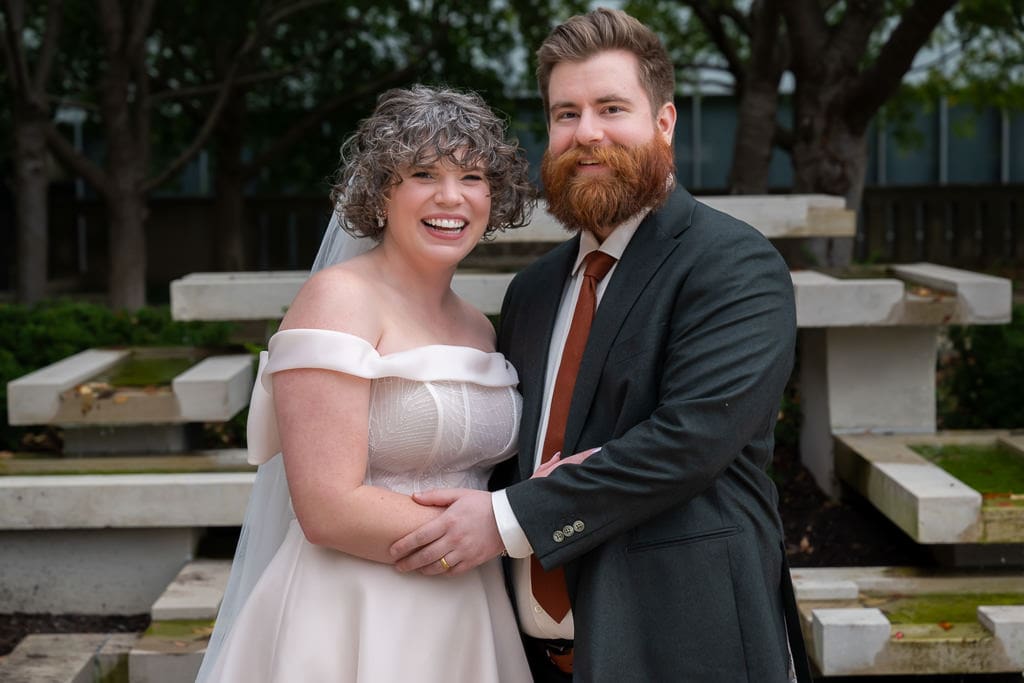 Bride and groom smiling together at the Nelson Atkins Museum of Art in Kansas City