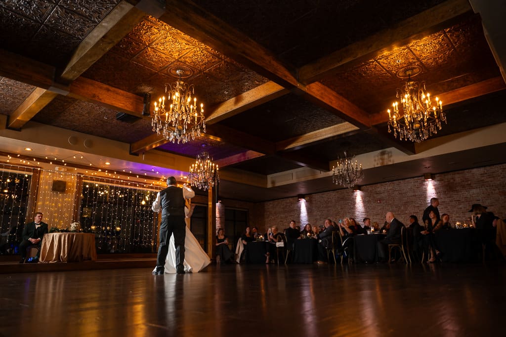 Wide view of The Stanley's chandeliers and wood ceiling as Tamieka shares a dance with her dad
