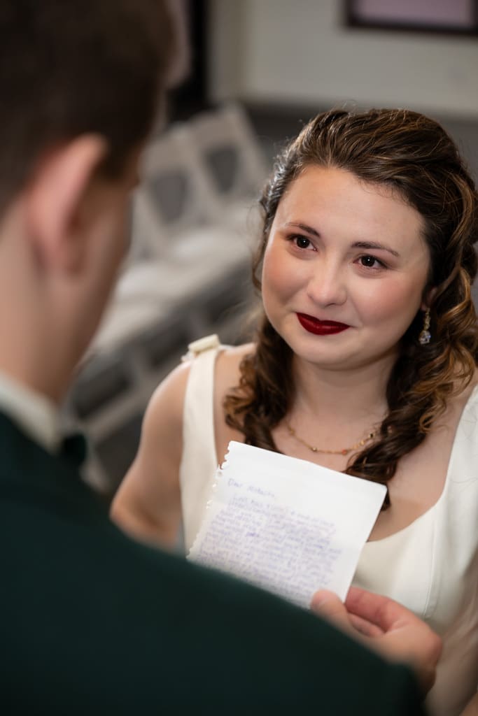 Tamieka smiles as Drake reads his vows to her