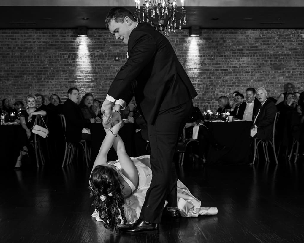 Black and white photo of Drake pulling Tamieka across the floor during their energetic first dance