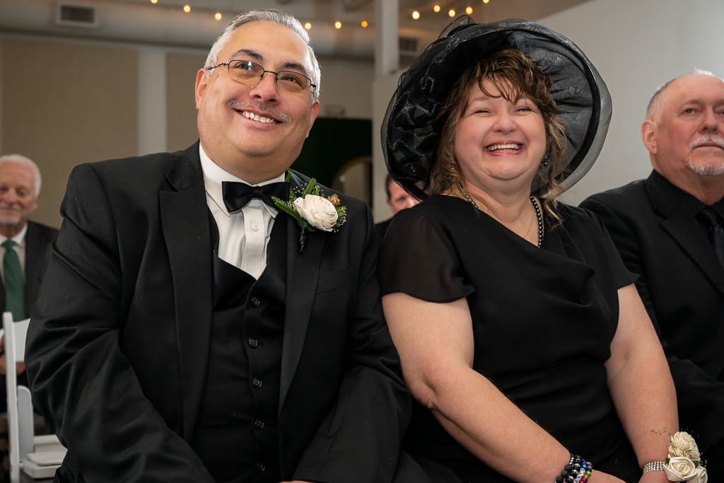 Tamieka's parents beam during the ceremony, her mom in a large black hat