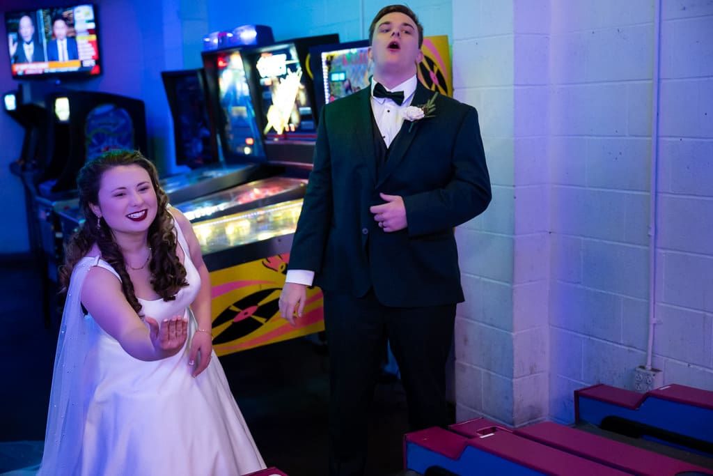 Tamieka and Drake goof around in front of pinball machines at Arcade Alley in downtown Lee's Summit